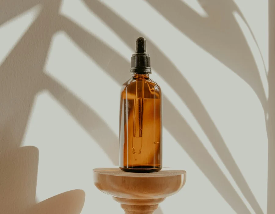 Amber glass dropper bottle on a wooden stand